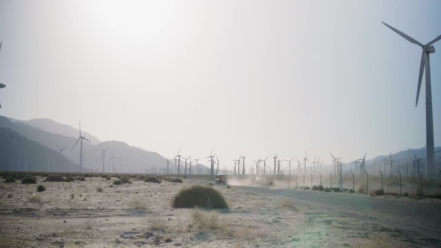 Windmills spin in a large open field