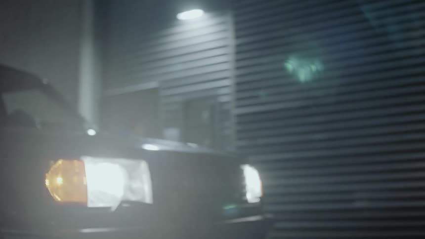 A car travels in the city at night