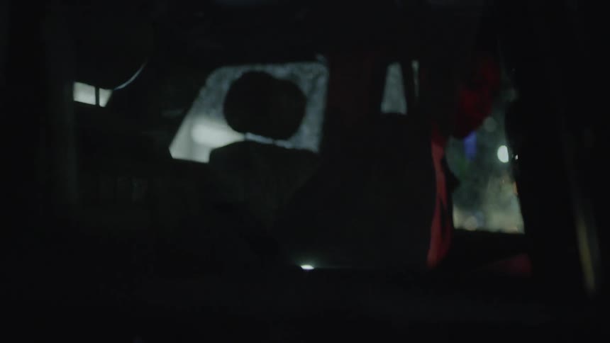Two people enter the backseat of a car