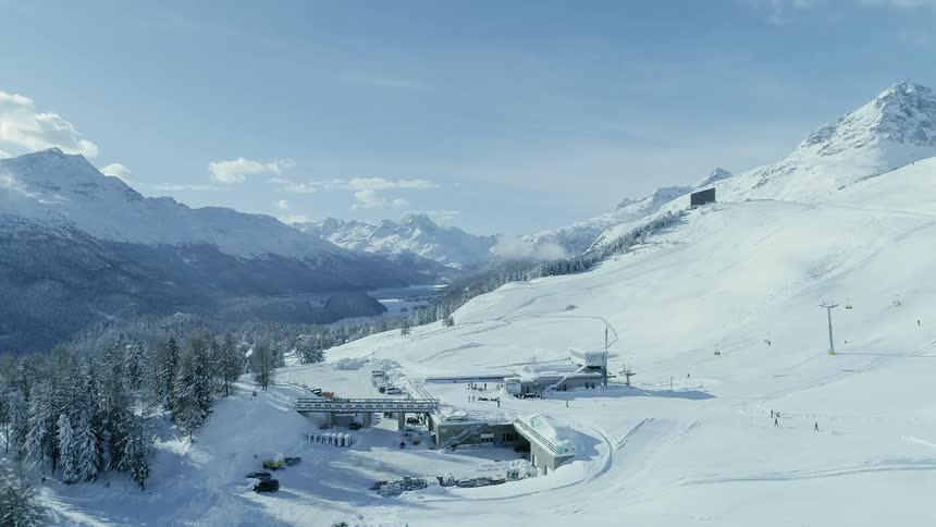 Skiers descend down the slope