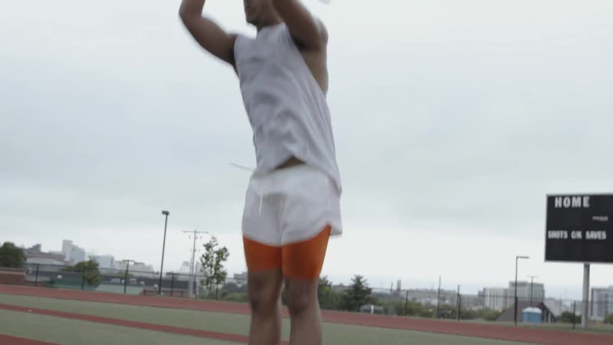 A man exercises on the athletic field