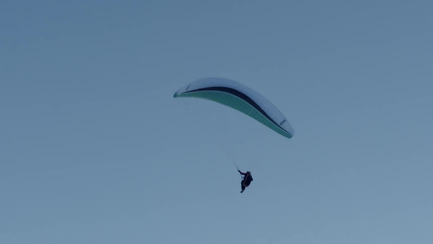 Person parasailing in the sky