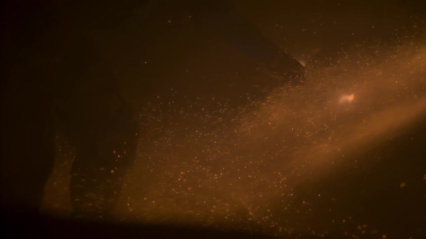 Man holding something that is on fire and sparking
