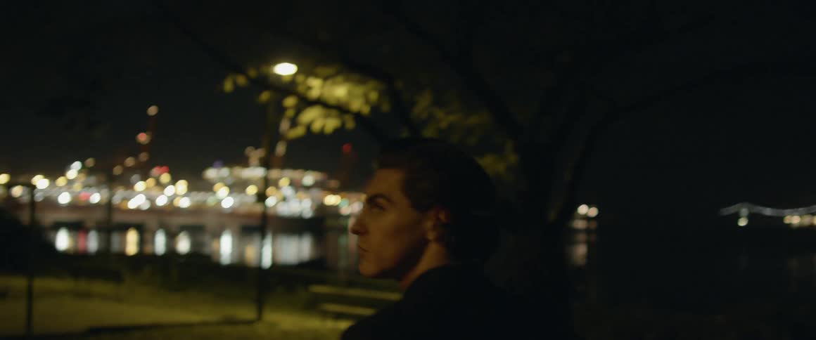 Man walks in the city park at night