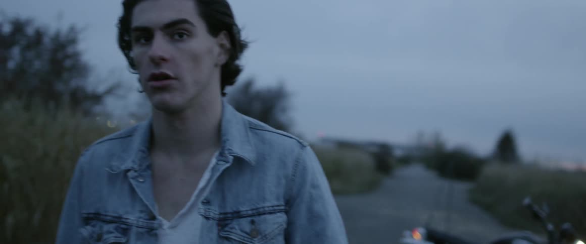 A man walks away from a motorcycle