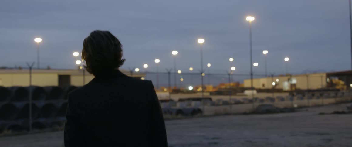 A man walks outside at night