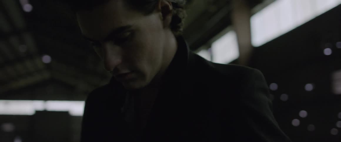 A man walks inside a warehouse building