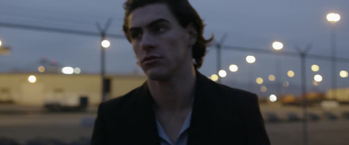 Man walks outside in the city at night