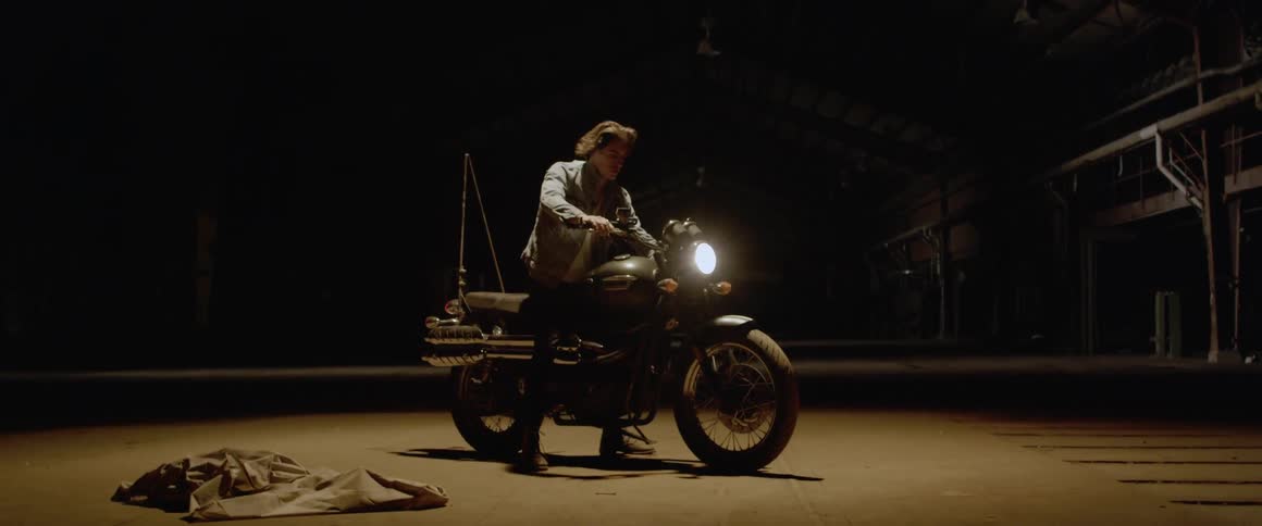 A man turns on a motorcycle headlamp