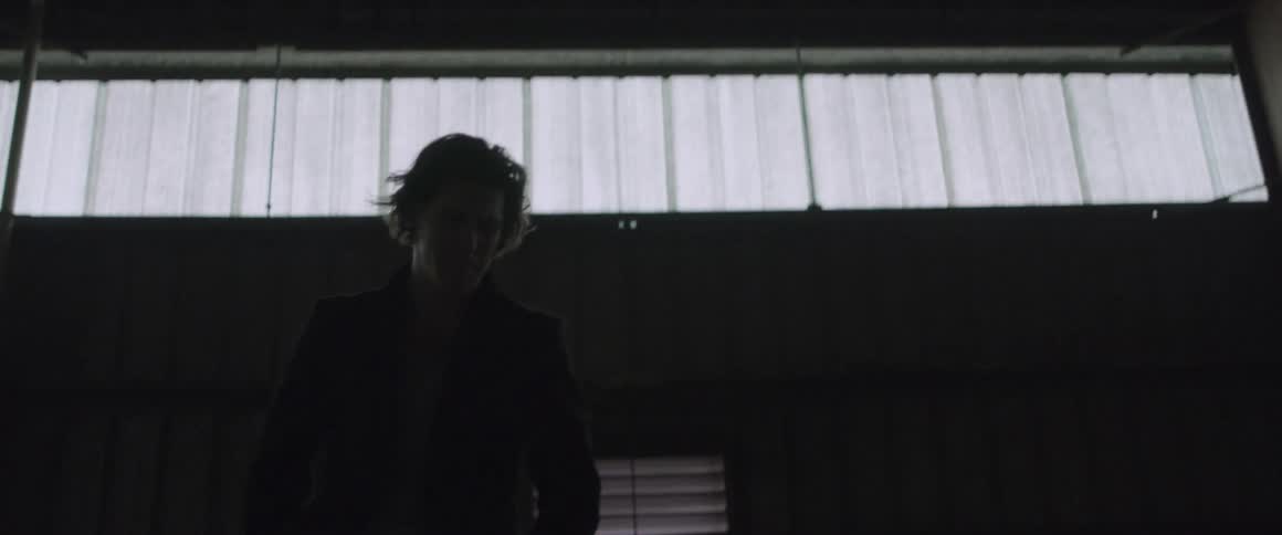 A man paces in a warehouse