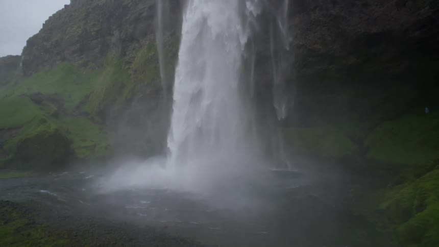 Large waterfall splashing into pool