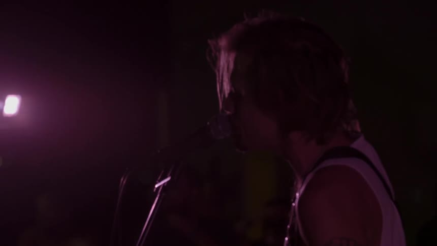 A man sings live at a concert