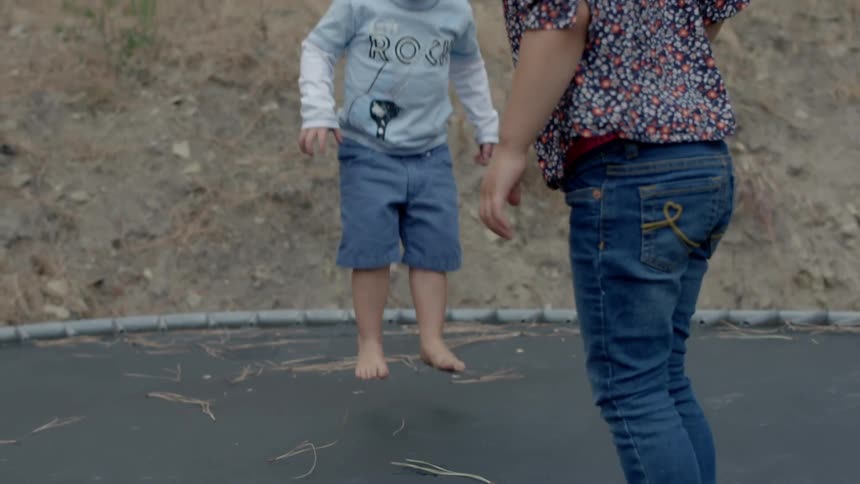 Children jump on a trampoline