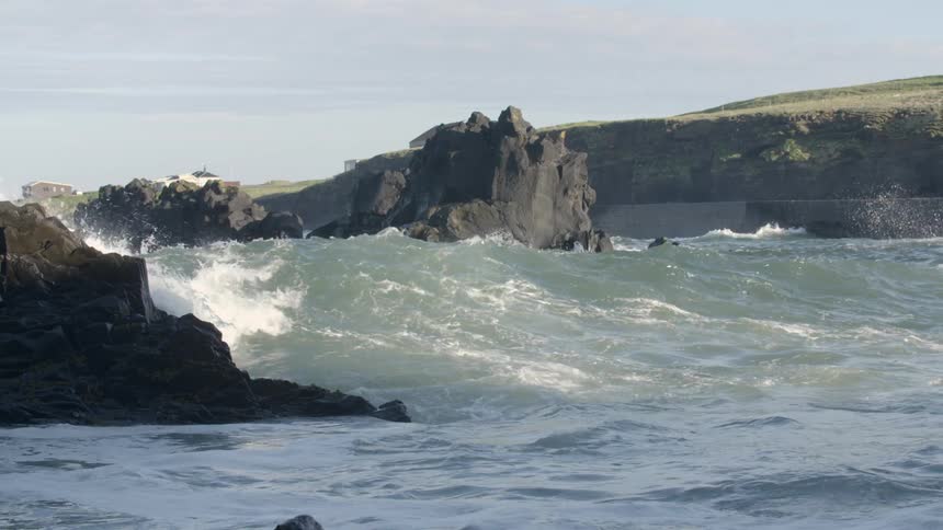 Waves crashing on some rocks in an inlet