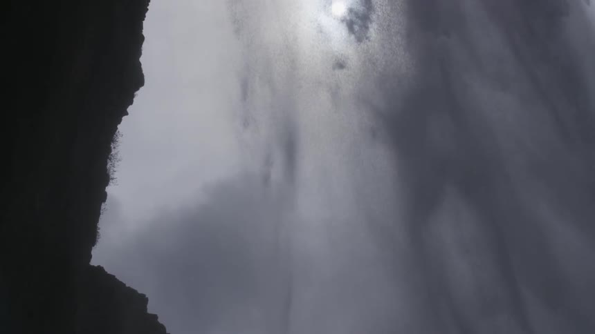 Water gushes over a cliff