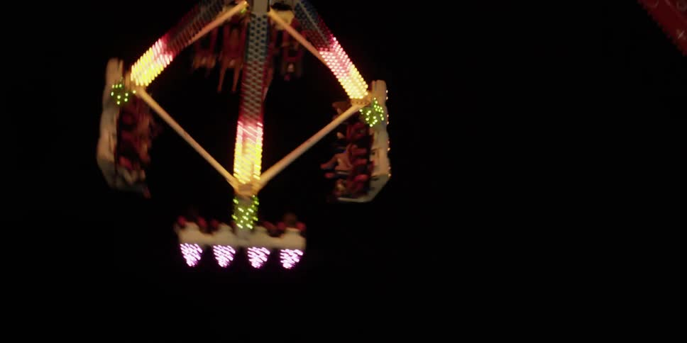A carnival ride swings and rotates in the air