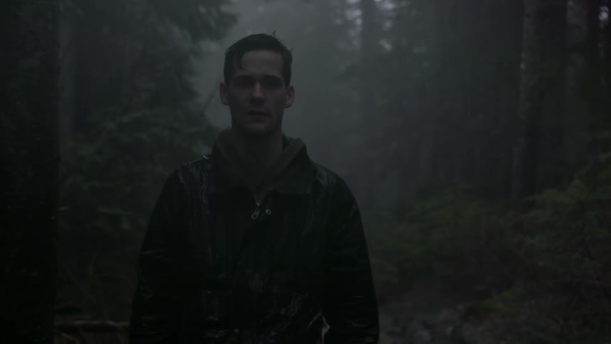 Man standing still in a forest