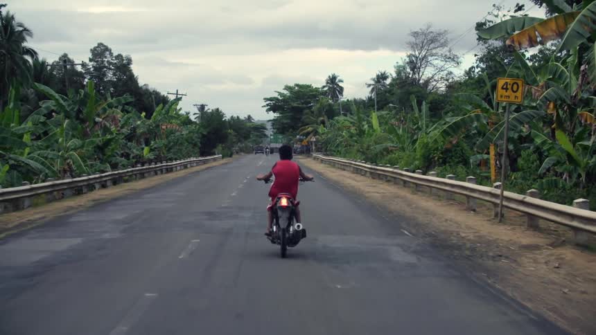 Man riding a motorcycle on a highway