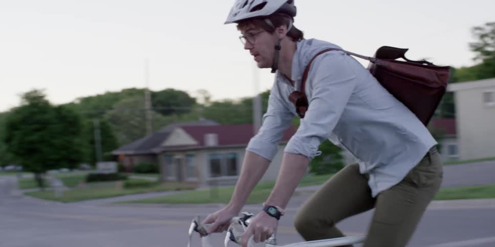 A man rides a bicycle in town