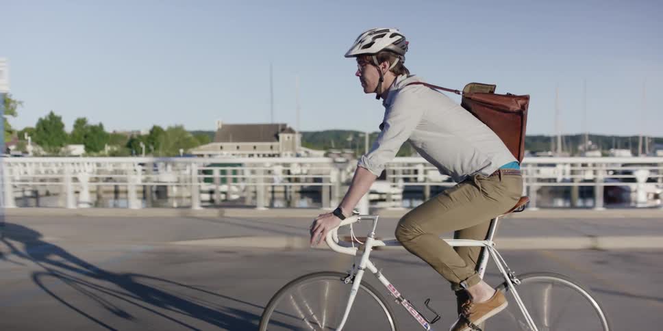 A man bicycles through town