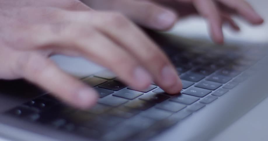 A man types on the laptop
