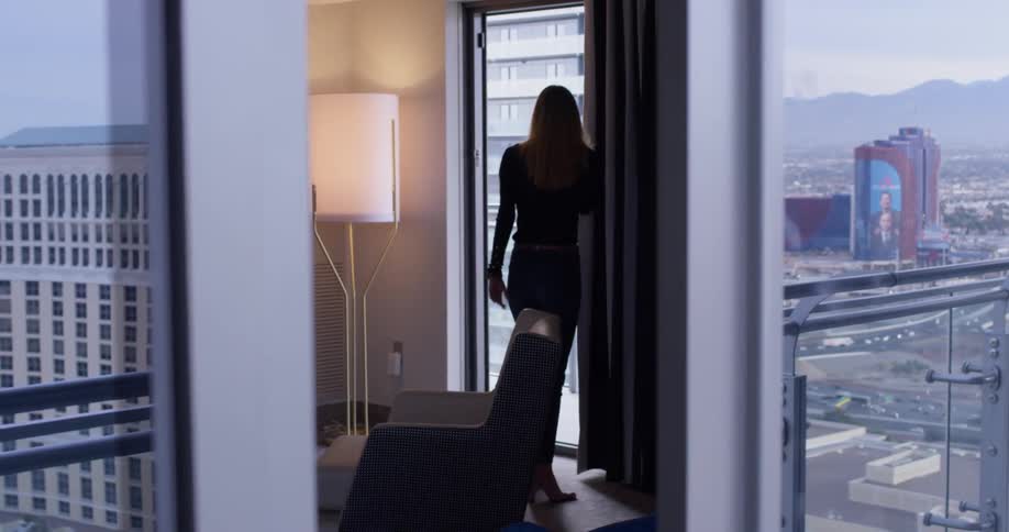 A woman uses a phone inside the apartment