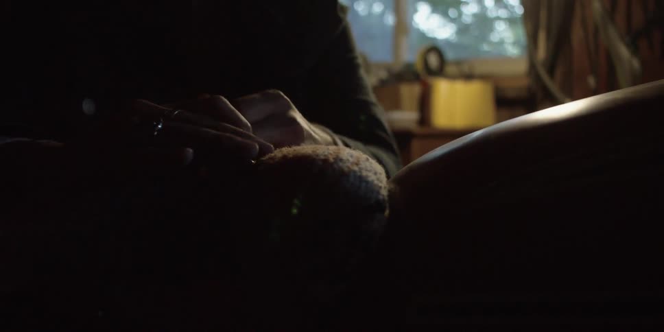 A man ties a string around an object