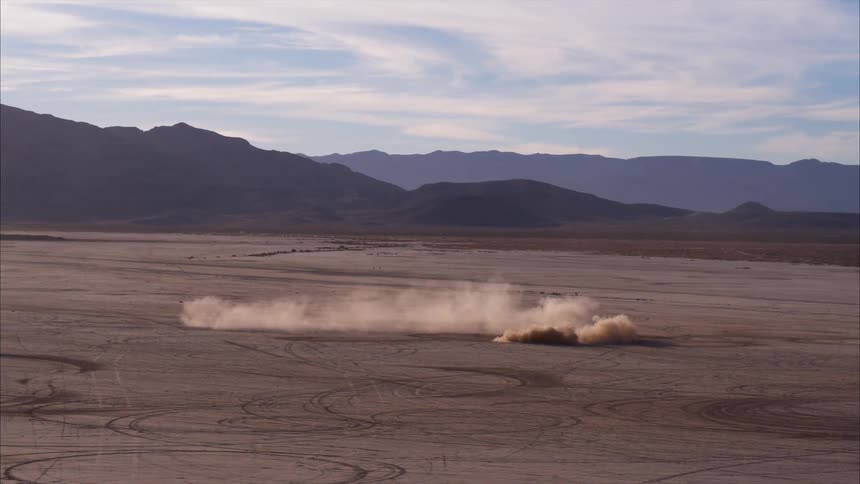A car spins out on the dirt