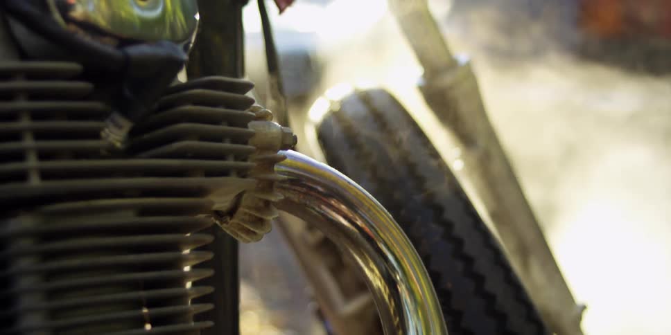 Smoke billows around a motorcycle wheel