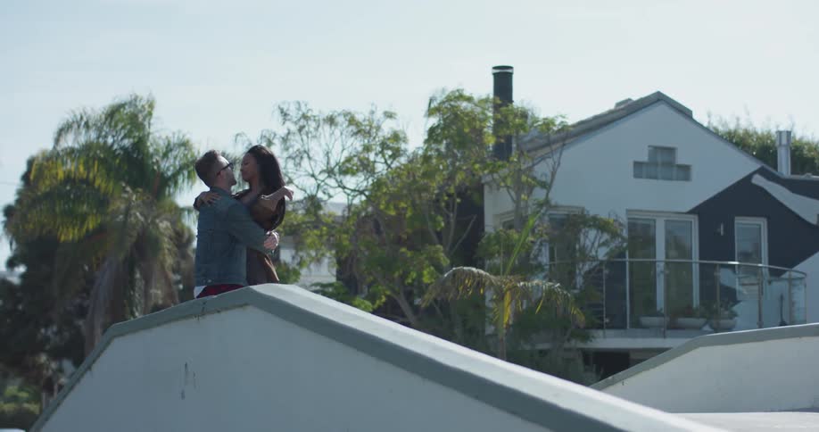 A man and woman hug on the bridge