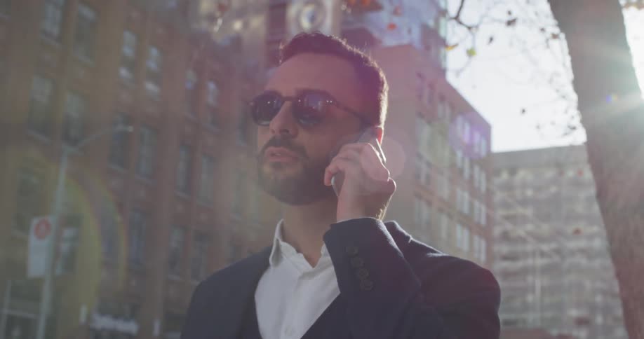 A man uses his phone outside