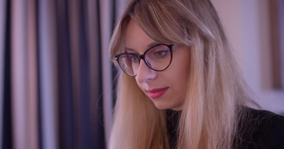 Woman wearing glasses looks down