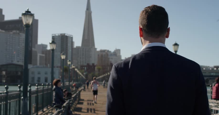A man walks on the city pier