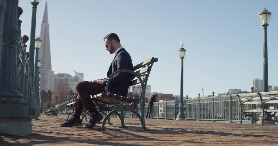 A man sits on a city bench