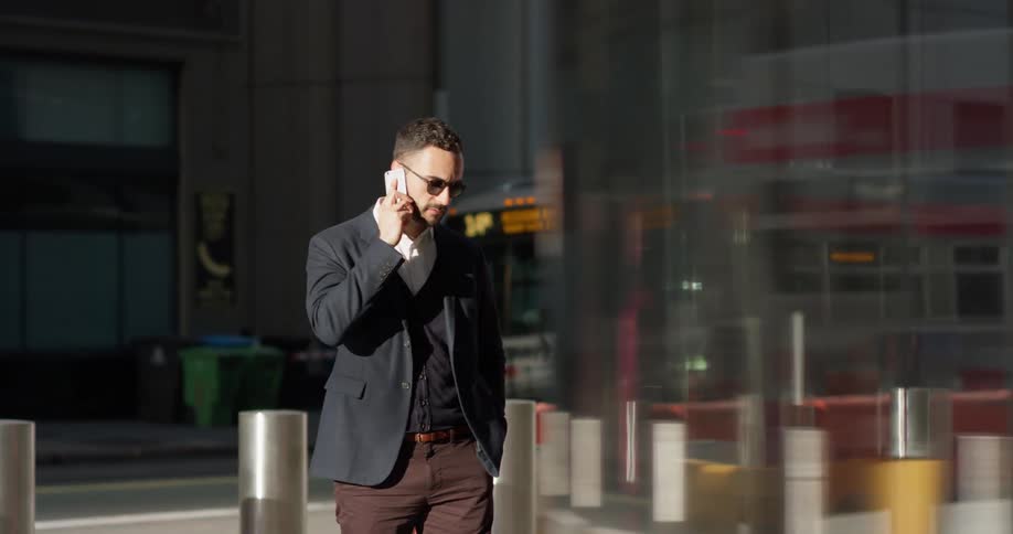 A man uses his phone outside