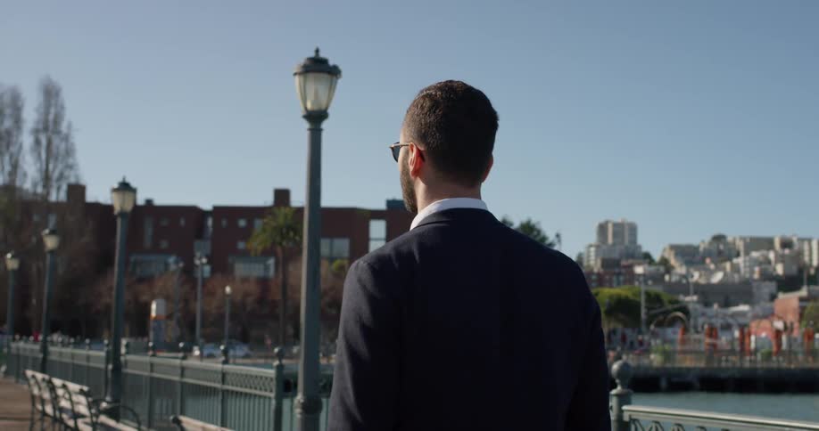 A man walks by city benches