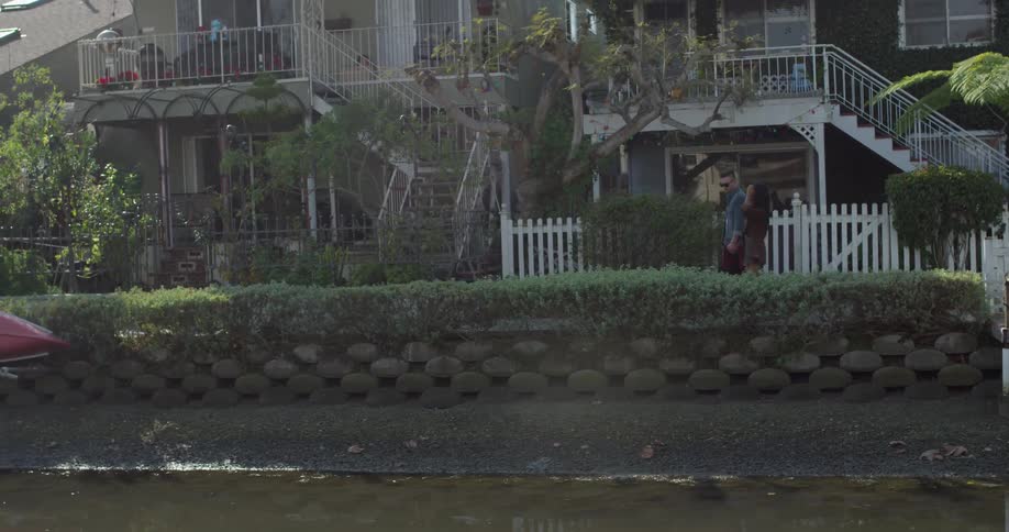 A man and woman walk together outside