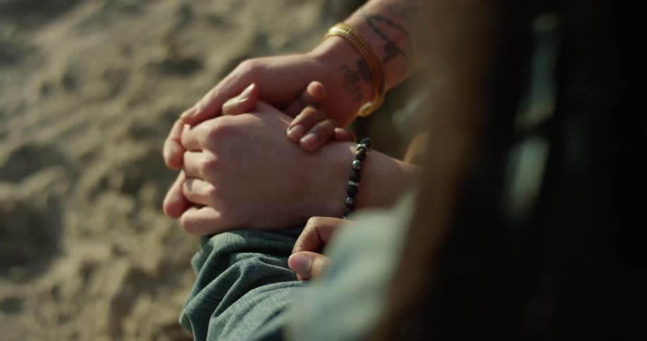 A man and woman hold hands
