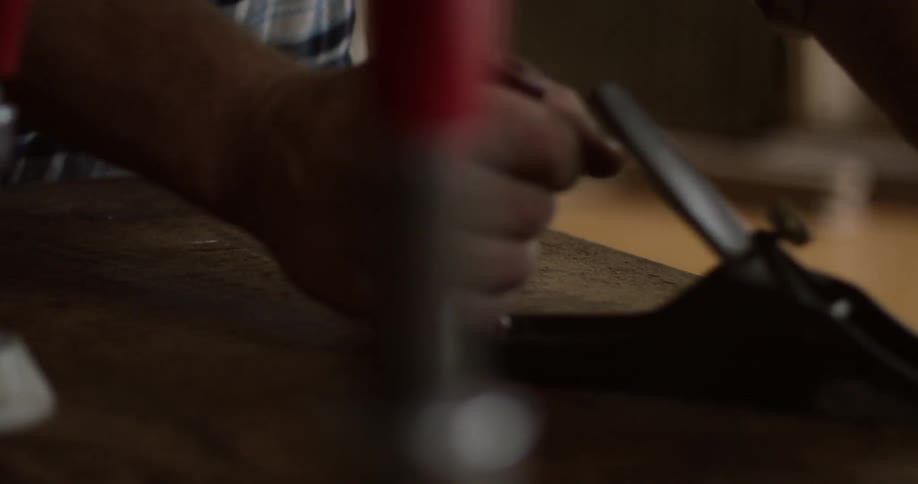 A man sanding with a hand tool