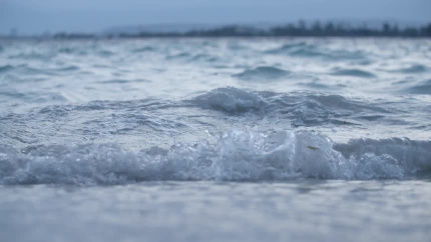 Waves rushing up on beach shore