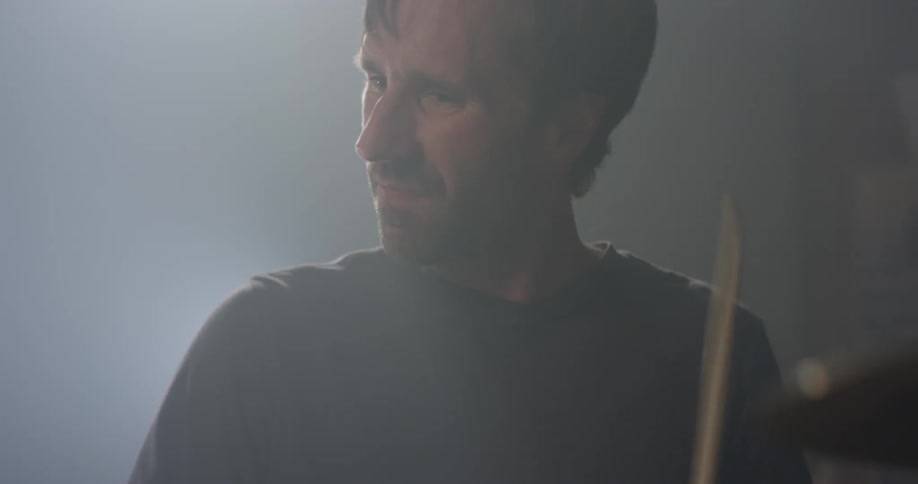 A man plays on the drum kit