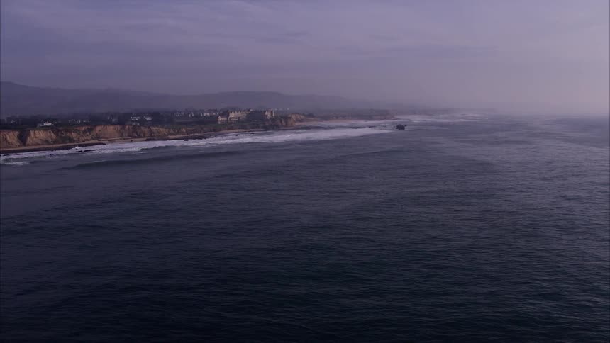 The tide rolls in towards the shore