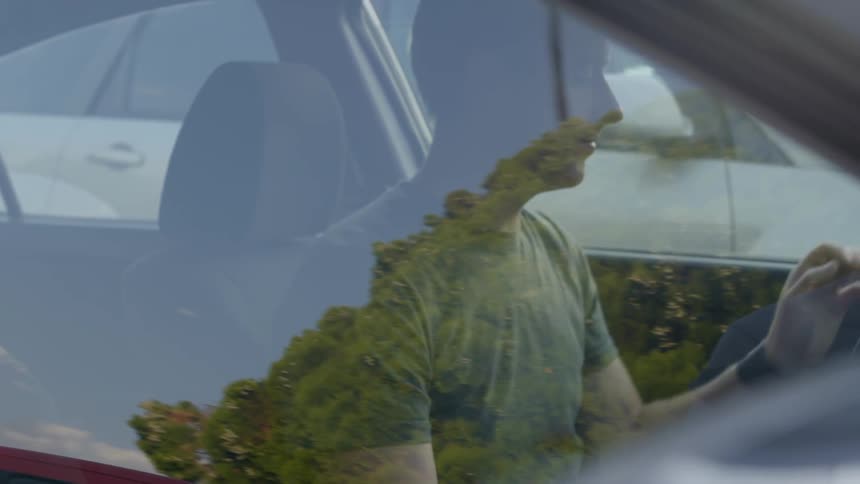 A man in his car during the day