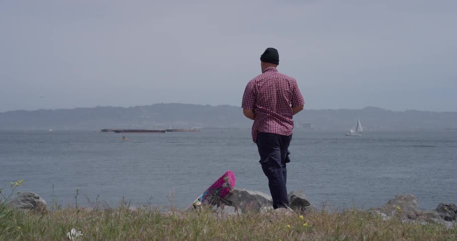 A man throws a rock into the water