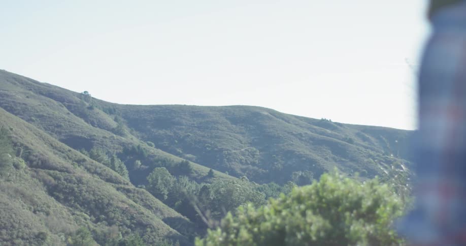 Sun shines over grassy hills