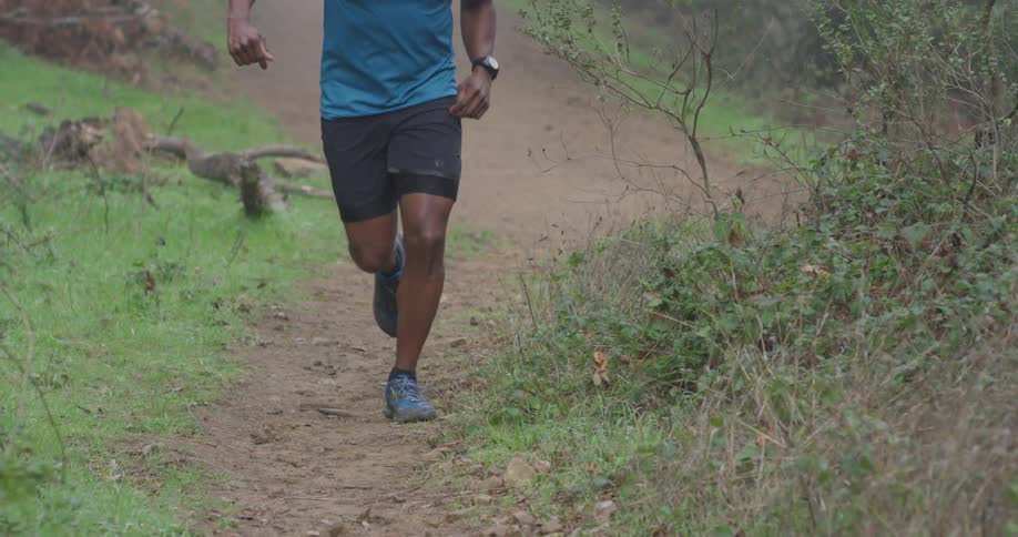 A man jogs on a dirt trail