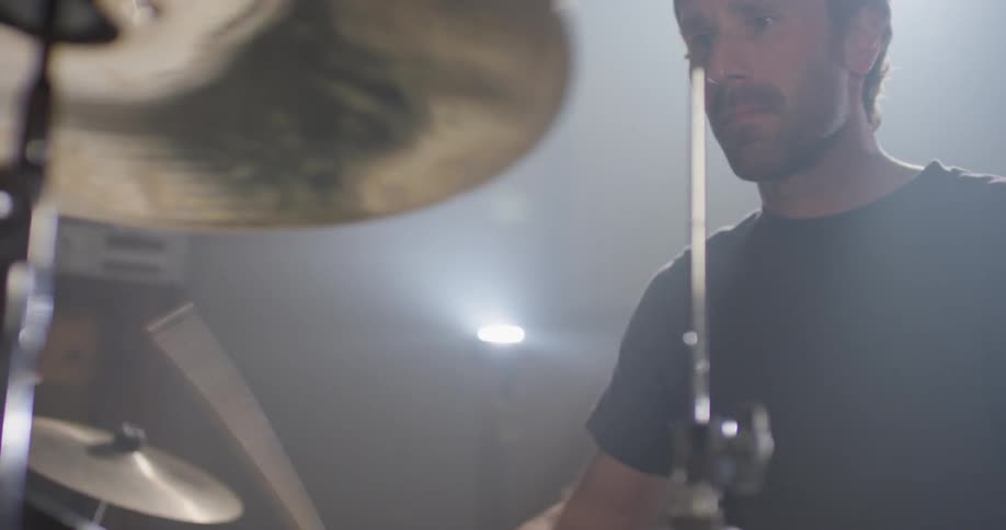 A drummer plays on the drum kit