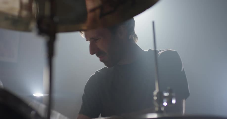 A drummer plays on the drum kit