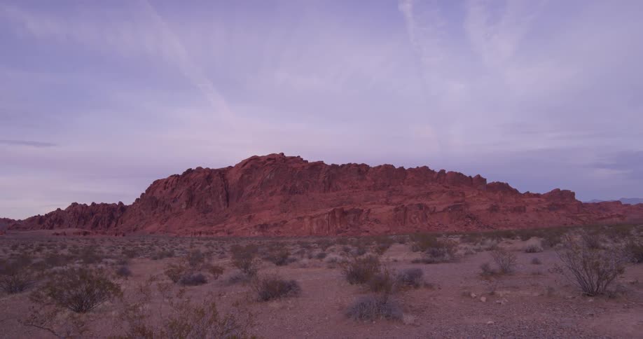 Red rocks cover a desert landscape