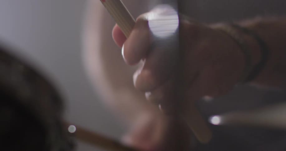 Person drums on a drum set